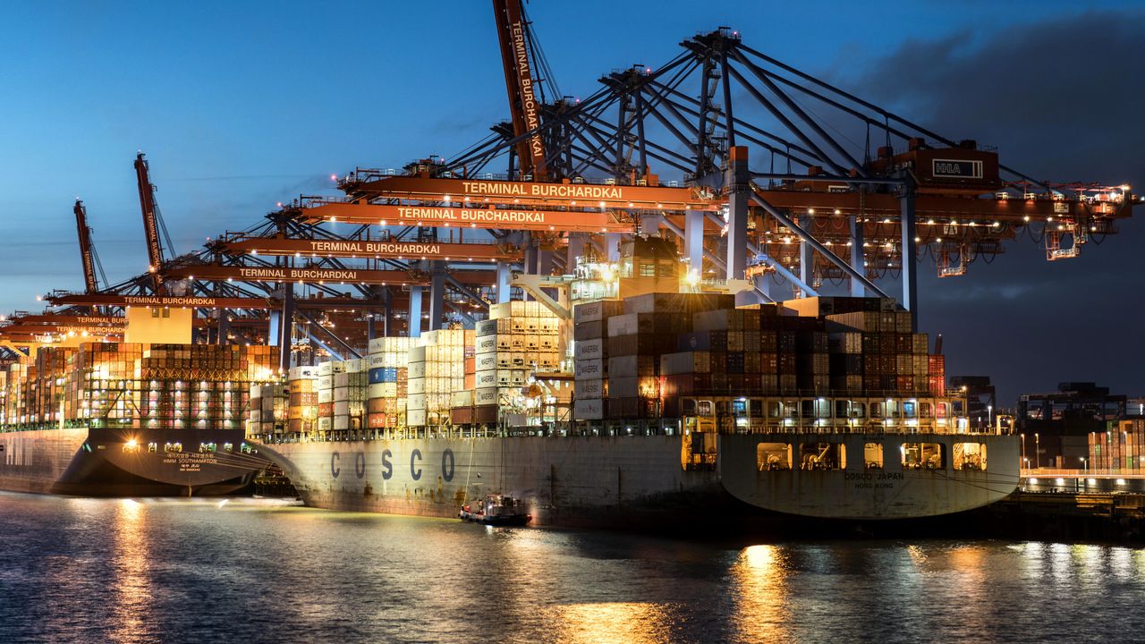 Container ship loading at a night-lit container terminal